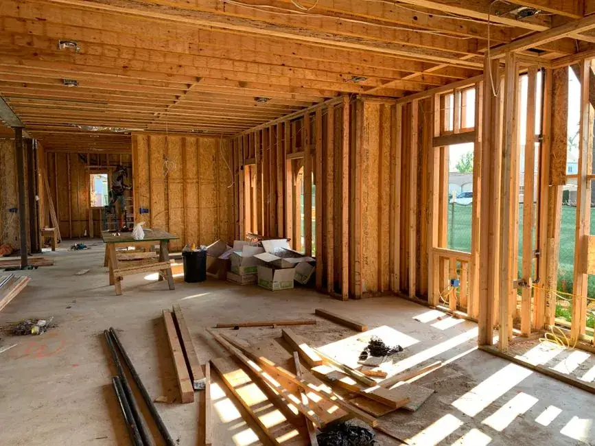 Timber stud framing during construction, the stage at which a concealed cistern frame is fixed in an Exeter bathroom