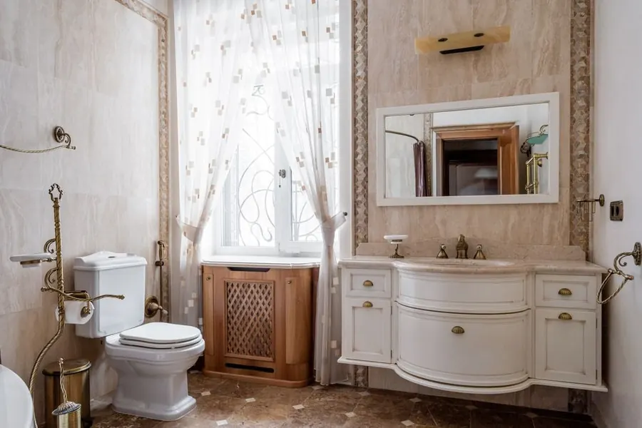 A traditional bathroom with period basin and brass taps, the kind of scheme that suits a listed Exeter home