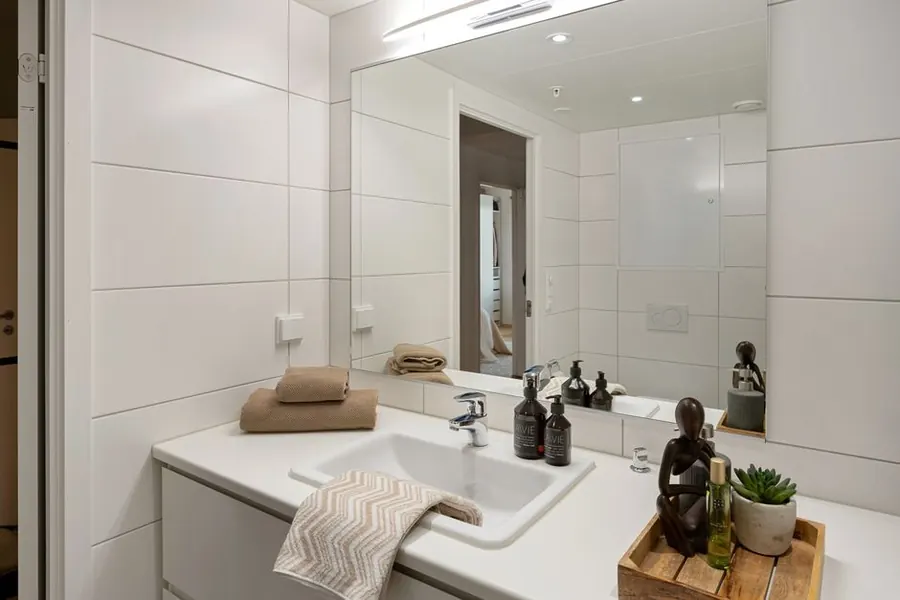 Folded towels on a clean bathroom vanity, the presentation standard guests expect in an East Devon holiday let