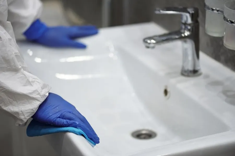 A bathroom being cleaned during a holiday let changeover in Devon
