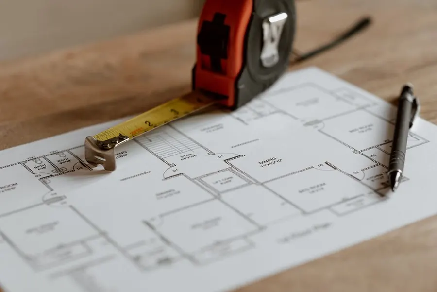 A floor plan, tape measure and pen, the drawings that go with a listed building consent application in Exeter