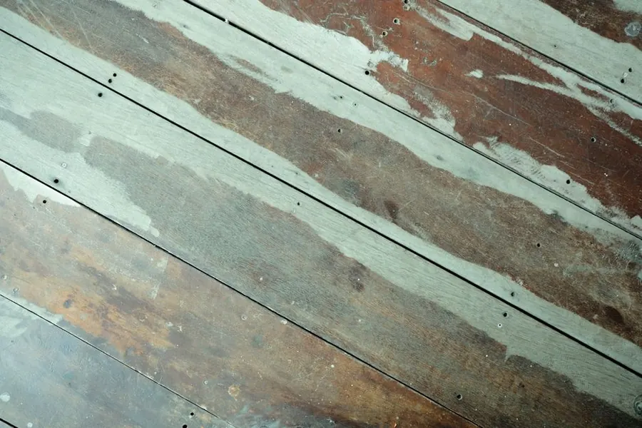 Worn old floorboards marked by generations of fixings, the floor a period Exeter bathroom has to be built on
