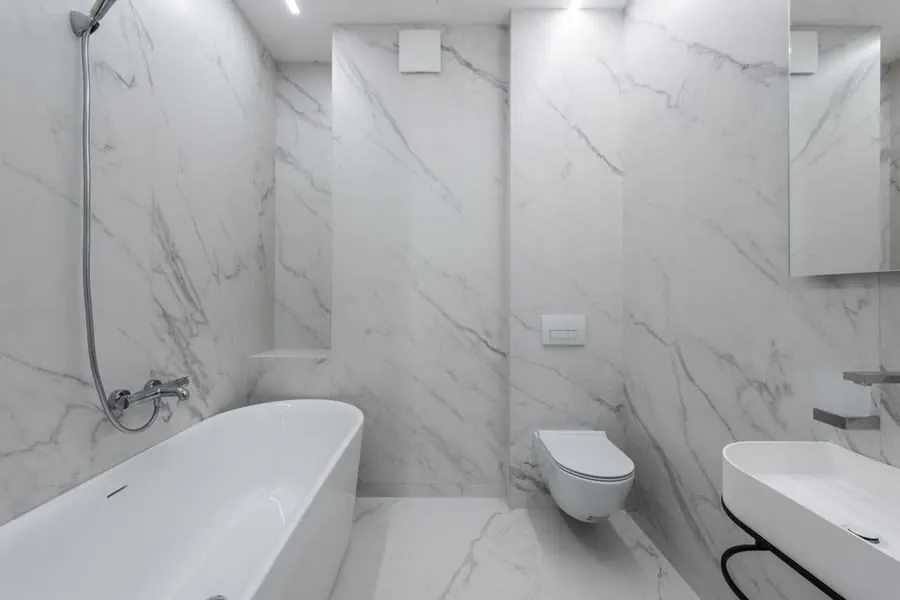 White freestanding bath in a marble bathroom of the kind priced in an Exeter renovation quote