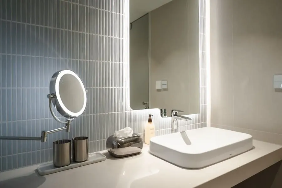 A fluted tile wall and basin in an Exeter bathroom, the kind of finish level a quote has to pin down in writing