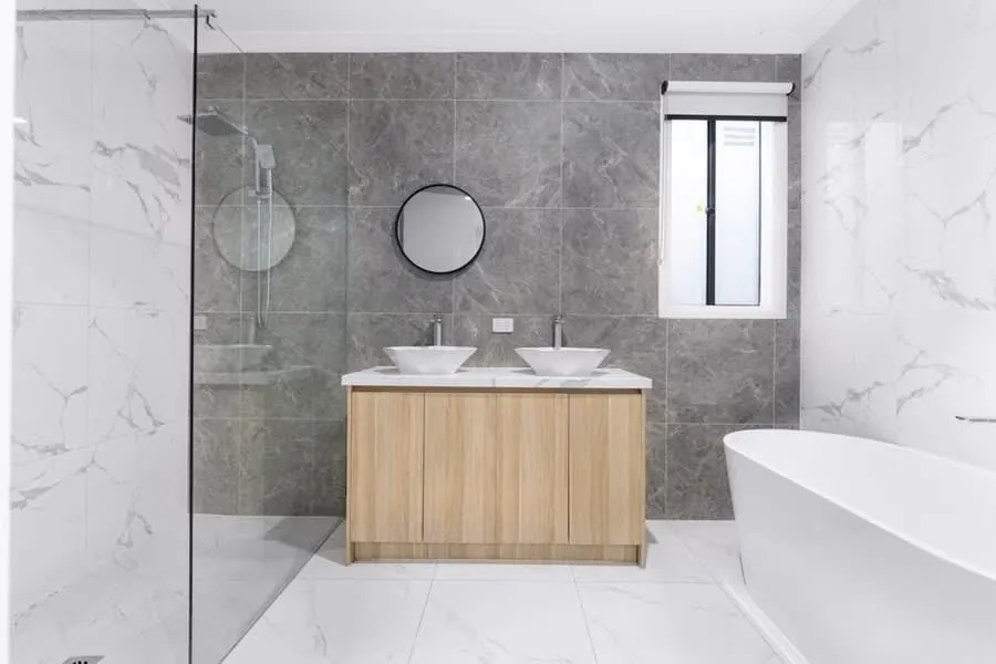 Marble bathroom with an oak vanity and freestanding bath, the specification level that holds value