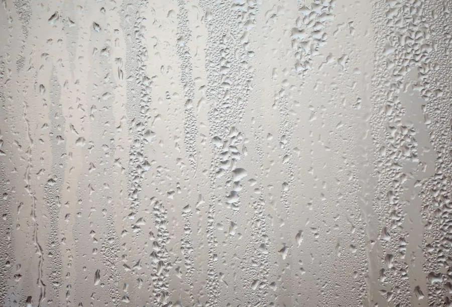 Condensation beading on a cold painted wall, the start of a bathroom damp problem