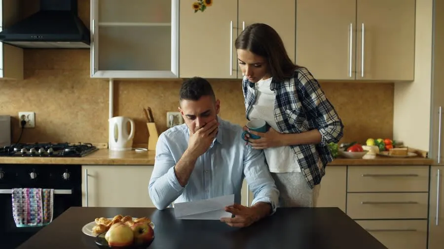 A couple in their kitchen reading through a contract before the cooling-off period ends
