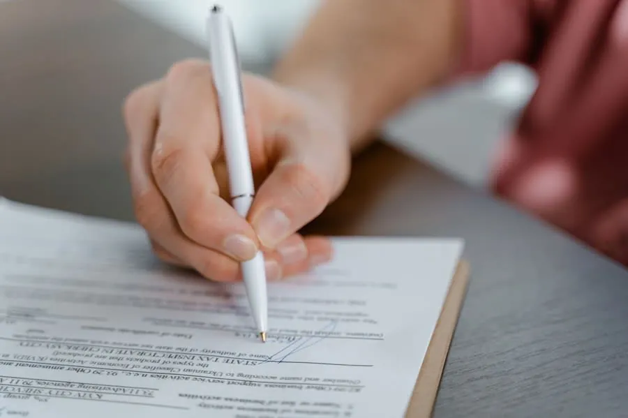 Signing a bathroom installation contract with a pen before paying a deposit