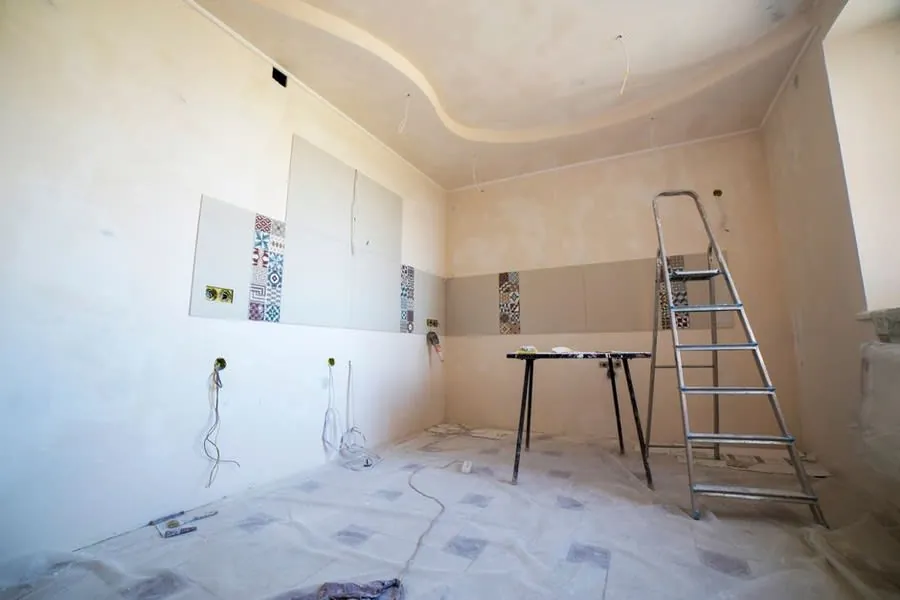 A room stripped back during renovation with bare walls and tools in place