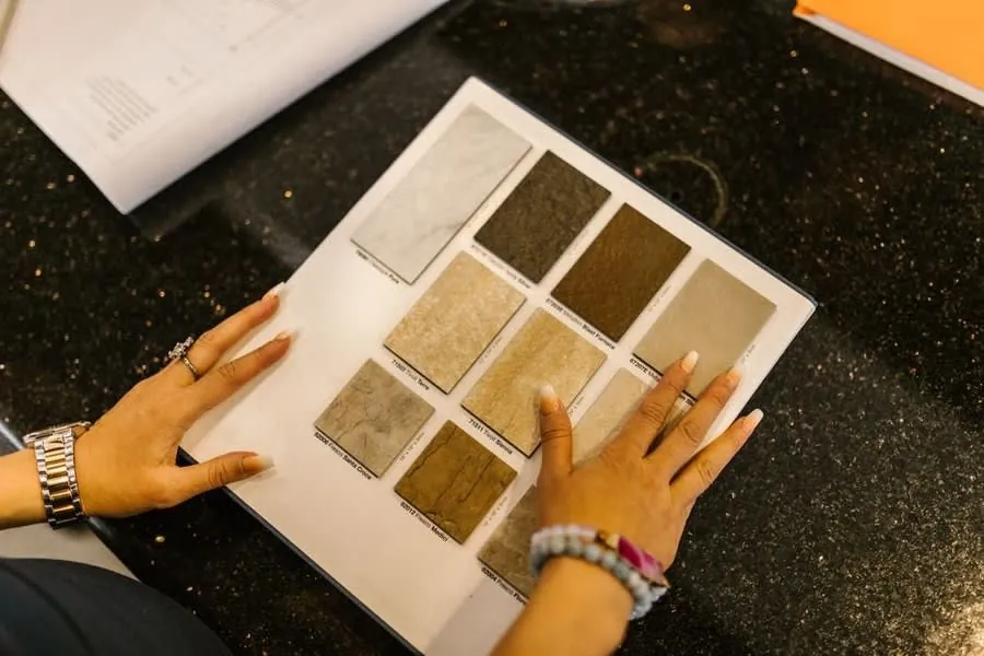 Stone sample board held over a worktop while comparing tile finishes