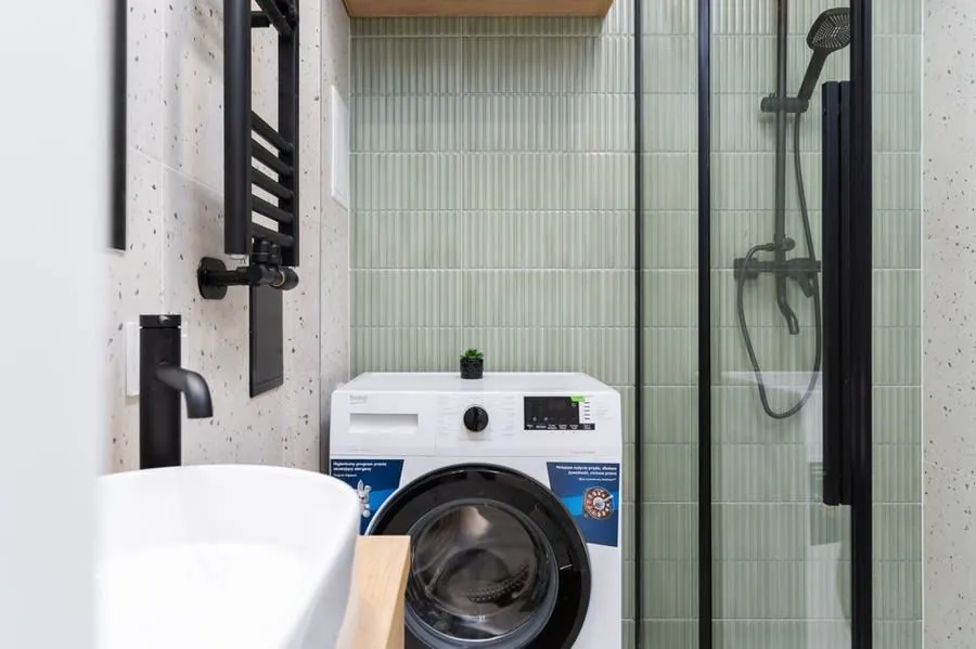 A wall-mounted tap over a small basin, typical of a well-specified cloakroom
