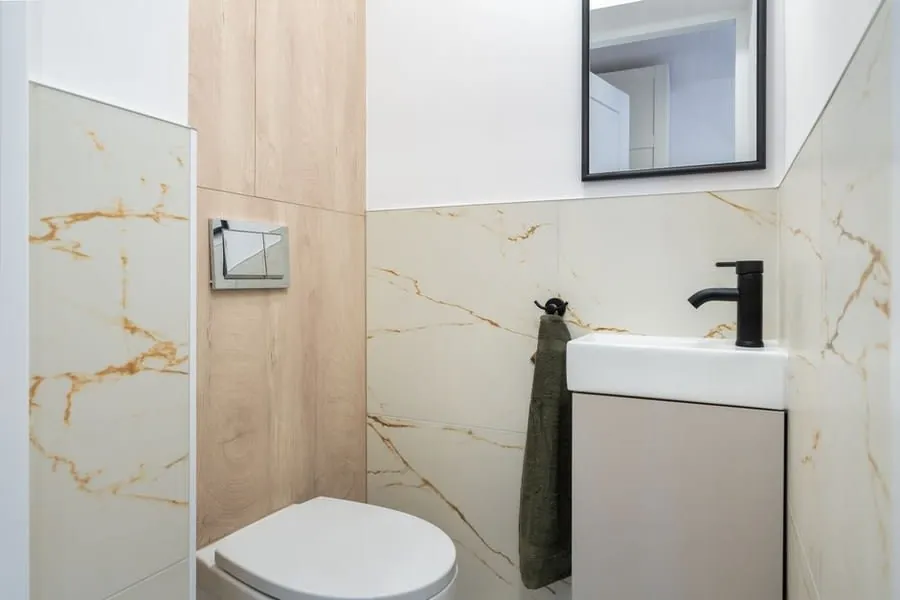 A compact cloakroom basin and unit with black tap beside a toilet
