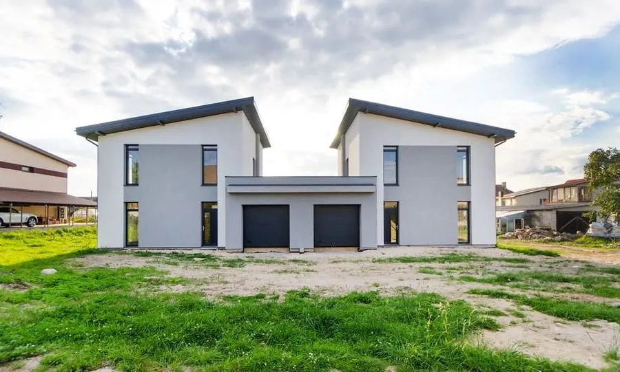 Newly built houses under construction, the kind of stock competing with older homes in Newton Abbot