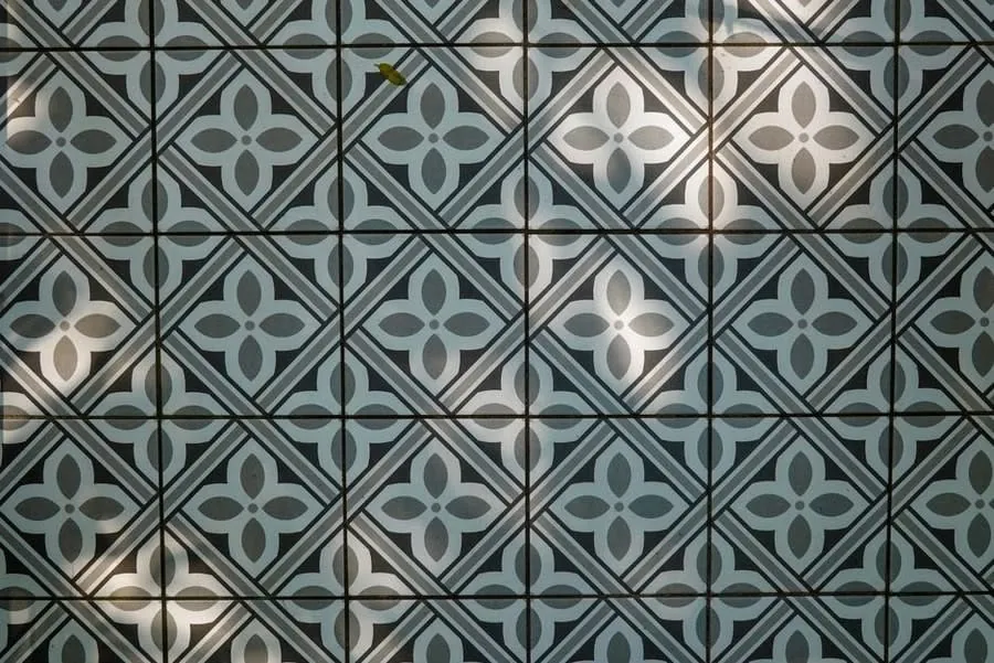 Patterned encaustic-style floor tiles in green and cream