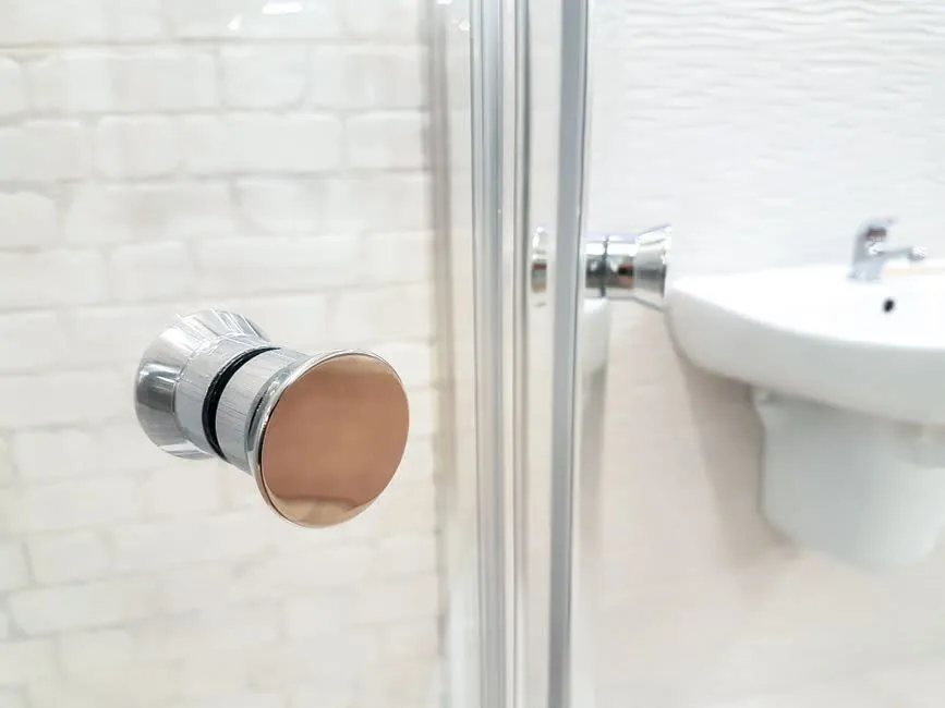 A glass shower enclosure and basin in a contemporary bathroom
