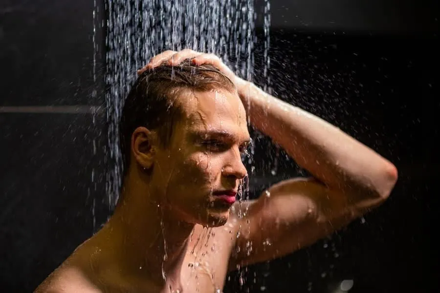 A person showering under a spray of water