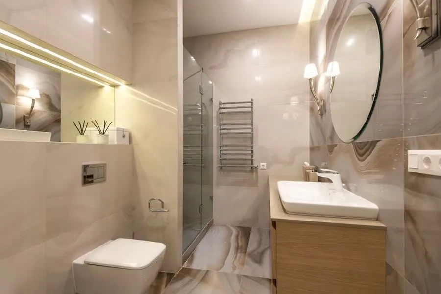 A small en-suite bathroom with a wall-hung WC and wood-effect floor