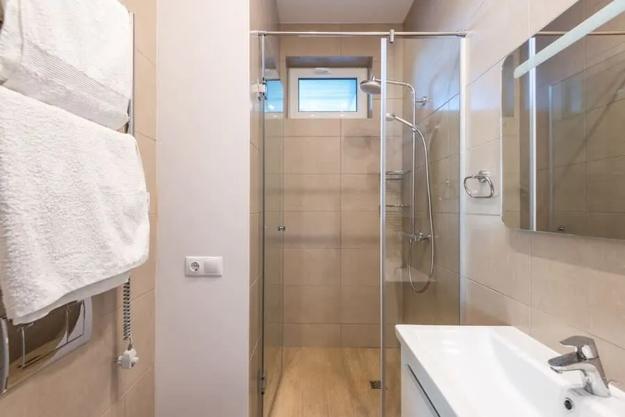 Compact shower room with a corner enclosure, typical of a small en-suite