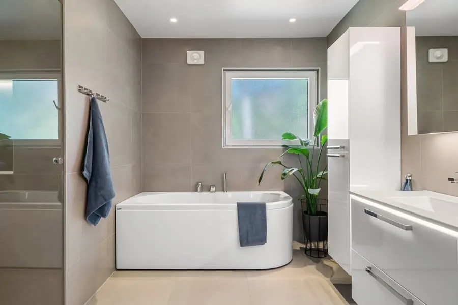 A spacious modern bathroom with clear floor space around a bath and vanity