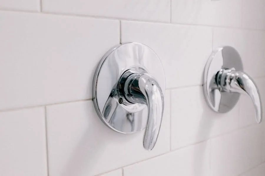 A lever-operated thermostatic shower mixer valve