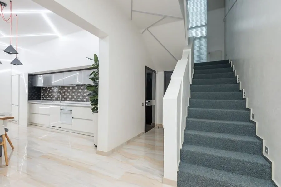 A staircase with the cupboard space beneath it, the usual home for a downstairs cloakroom