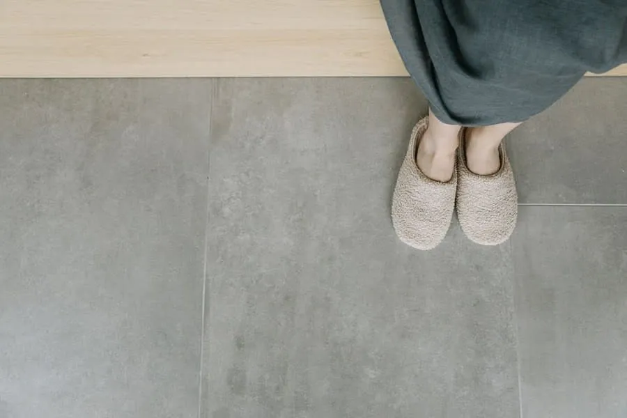 Slippers on a large-format grey tiled floor, the surface underfloor heating warms