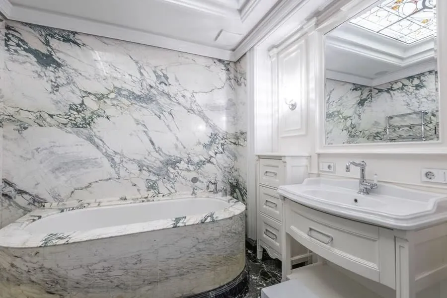 Green marble bathroom with a built-in bath, a design reference for Exeter installations