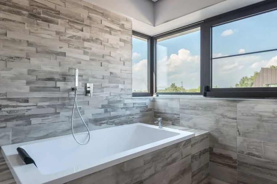 A bath in a light-filled East Devon coastal bathroom of the standard holiday let guests now expect