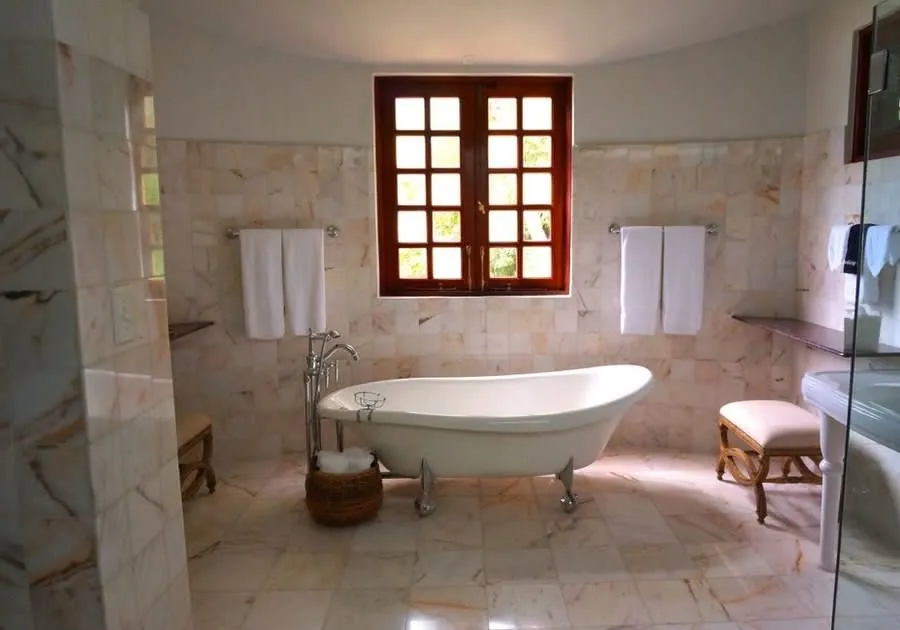 A period bathroom with a clawfoot bath and marble surround in an Exeter listed home